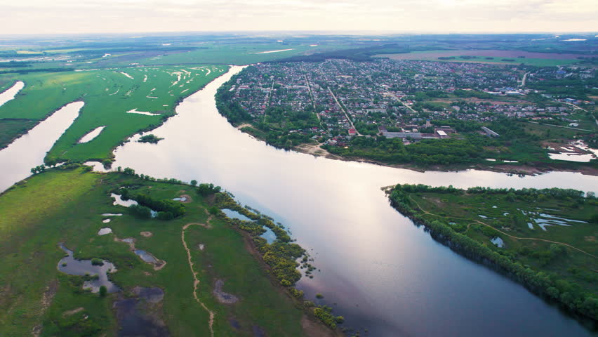 Aerial view of a river bending around a town