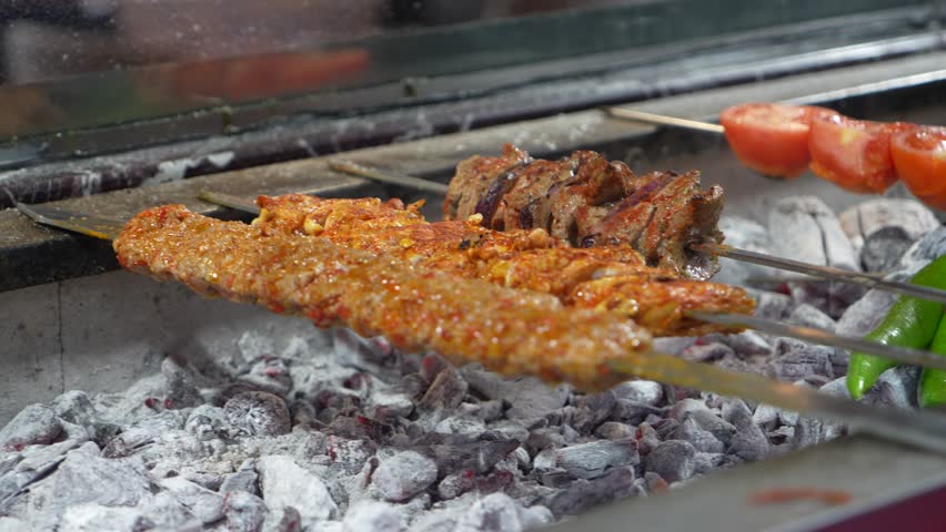 A video showing the preparation of traditional Turkish kebab. The video shows Turkish food being cooked, specifically Adana kebab portions.