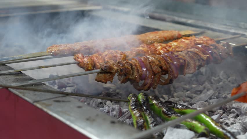 A video showing the preparation of traditional Turkish kebab. The video shows Turkish food being cooked, specifically Adana kebab portions.