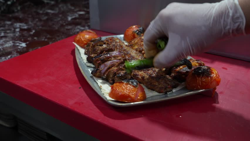 A video showing the preparation of traditional Turkish kebab. The video shows Turkish food being cooked, specifically Adana kebab portions.