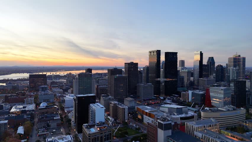 Montreal downtown skyline at sunset with modern skyscrapers, city buildings and warm evening sky, Quebec, Canada. g