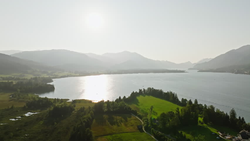 Aerial view landscape Wolfgangsee Austria. Sunset over the lake in the Alpine mountains, tourist Europe.