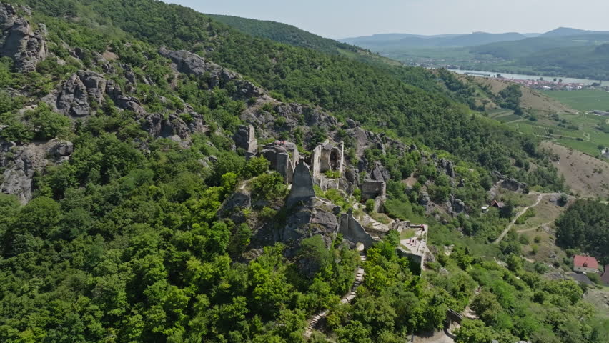 Aerial view of the ruins of an old fortress in Durnstein Austria surrounded by the Wachau Valley landscape and the Danube River in a scenic tourist region