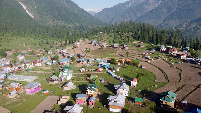 Top Landscape view of hill side homes with forest and distant mountains