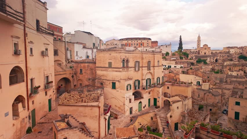 Matera old town in Basilicata, Italy. Prehistoric Sassi cave dwellings carved into limestone, creating a stunning landscape in one of the oldest cities in the world. Slow panning shot