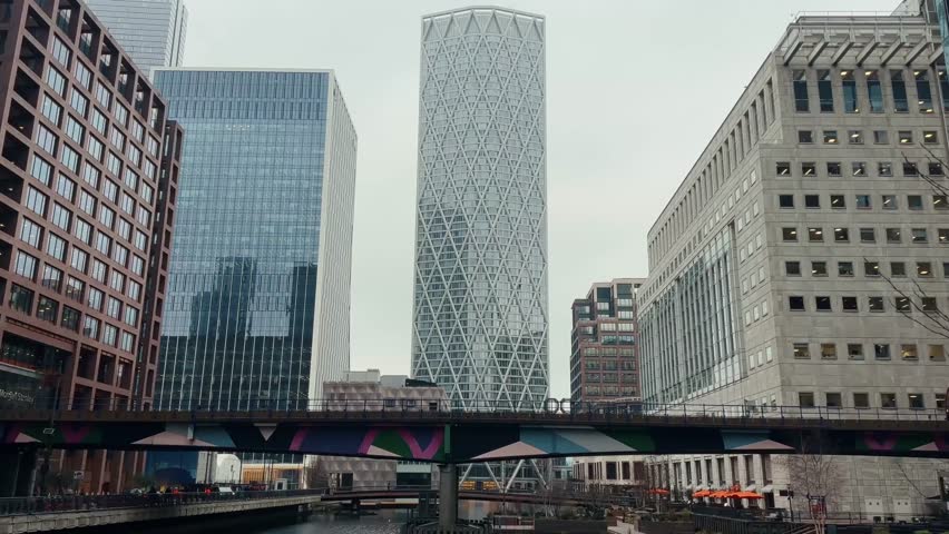 City canal flowing between modern office buildings with urban architecture and waterfront business district.