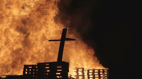 burning christian cross in 1080p. fire burns the church caused by terror