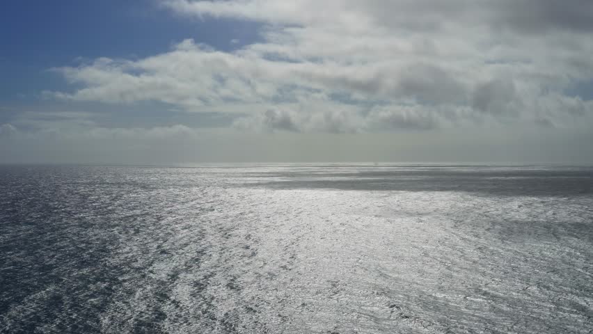 Vast ocean under a cloudy sky.