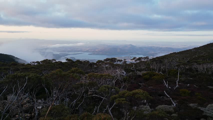 Hobart, Australia: Cinematic aerial drone footage of a revealing view of Mt Hobart from the Mt Wellington mountain in Tasmania in Australia. 