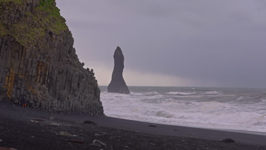 Basalt columns and crashing waves at Reynisfjara Beach in Iceland