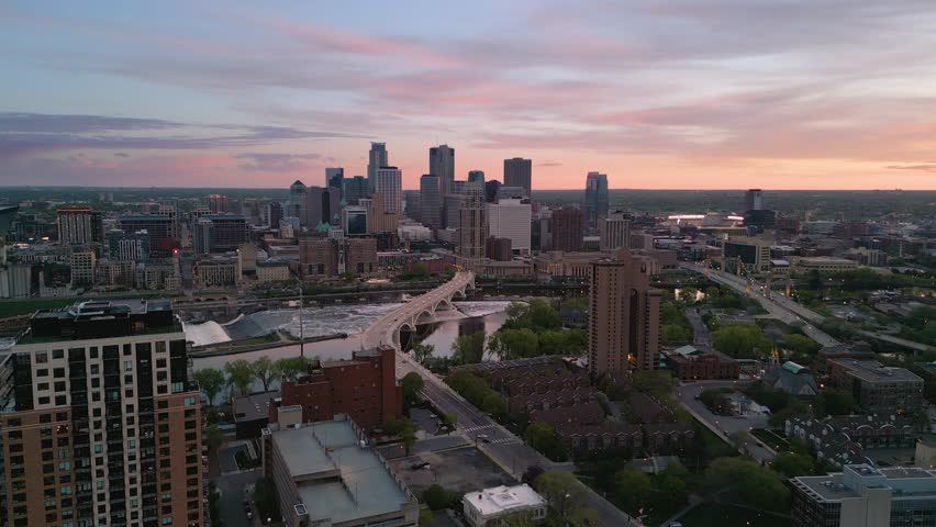 Minneapolis, Minnesota, USA downtown city skyline over the river at dusk.