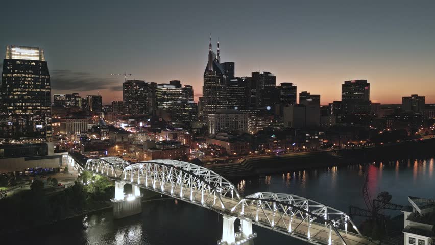 Nashville, Tennessee, USA skyline over the Cumberland River at golden hour.
