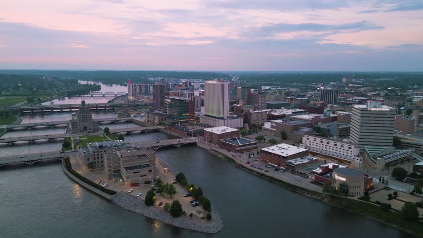 Cedar Rapids, Iowa, USA cityscape on the Cedar River at dusk.