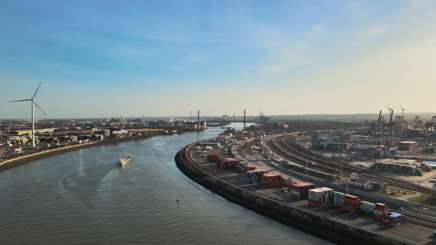 Aerial view of river port with industrial buildings and transportation infrastructure.