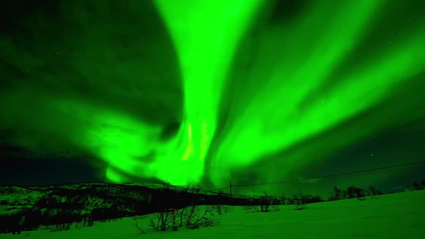 Stunning Real Time Aurora Borealis Dancing Over Snowy Mountains, Intense Green Northern Lights in Night Sky
