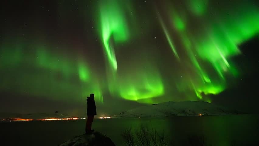 Breathtaking Time-lapse of Magical Aurora Borealis Dancing in the Night Sky Over Snowy Arctic Mountains