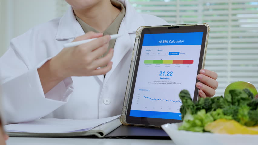 Asian woman nutritionist showing AI BMI calculator on tablet and explaining to senior patient, doctor using digital health technology for medical diagnosis, wellness planning and weight control.