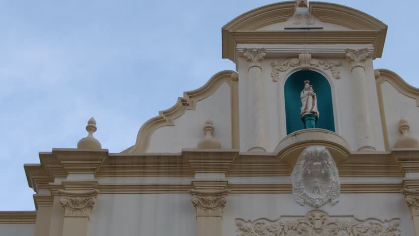 Low angle shot of a historic cathedral facade and bell tower under soft daylight