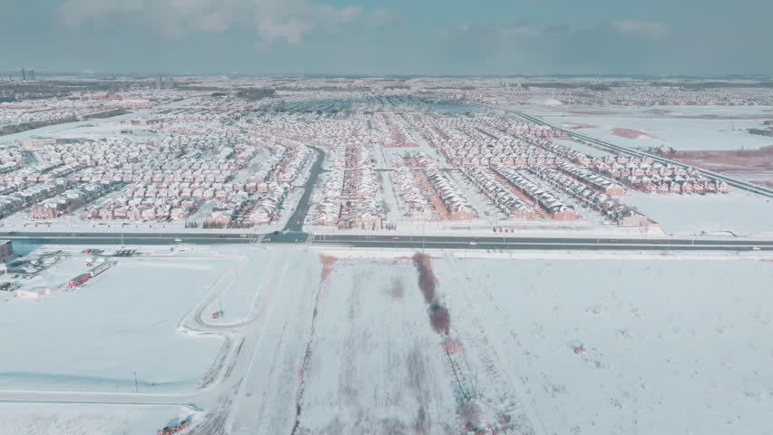 Aerial view of snowy Milton, Ontario suburb in winter