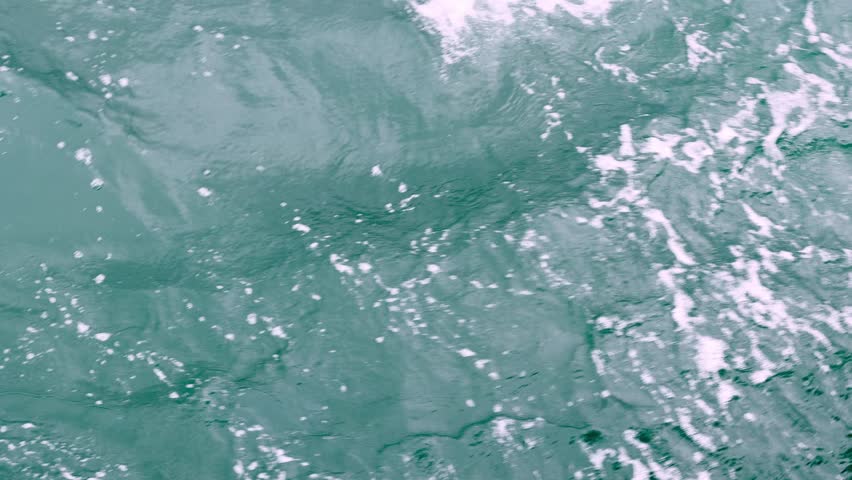 water and suds ripple as boat pushes forward
