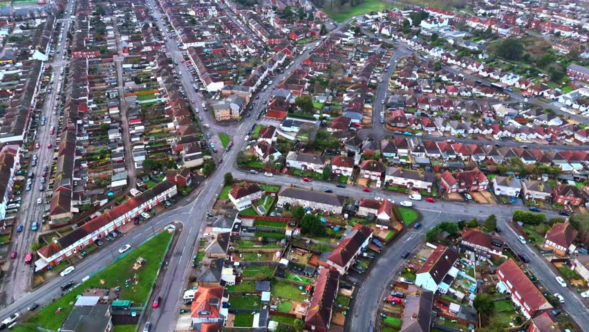 aerial landscape drone shot panning over the Woolston and Itchen suburbs of Southampton, Hampshire. With lots of houses and fields and trees lining the busy roads in the area on a winters day