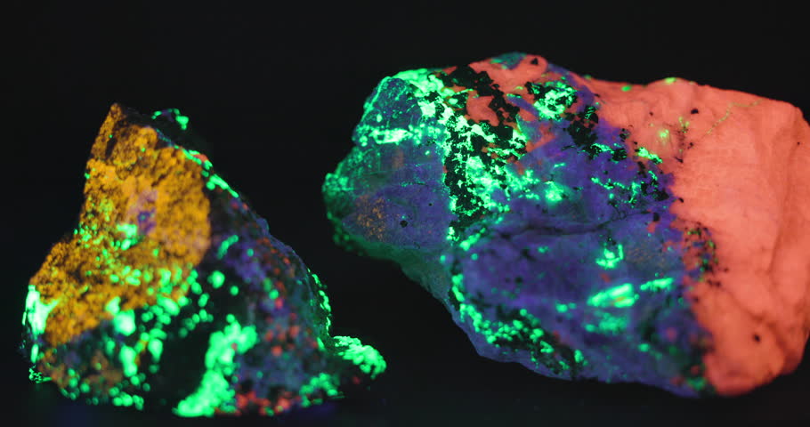 thsi is a video of a rock glowing under the black light made up of Clinohedrite: yellow orange. Hardystonite: Blue Violet. Calcite: Red Orange and Willemite: Green found in the franklin mine New Jersey
