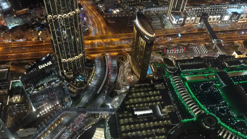 Aerial night view of Dubai’s skyline, showcasing Marina Bay Sands Resort, illuminated skyscrapers, and vibrant city lights in a breathtaking panorama.