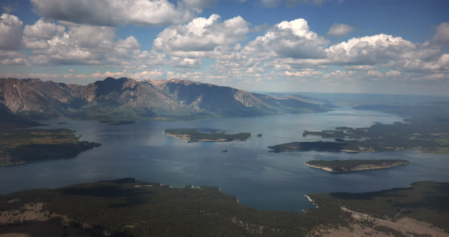 this is a video of Jackson Lake and Grand Tetons Aerial Landscape, Summer shot from a plane. aerial footage