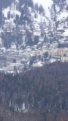 Snow falling over the famous alpine resort town of st. Moritz in switzerland during winter season