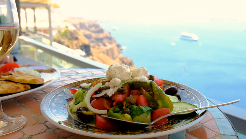 Greek salad and wine in Greece in a restaurant. Selective focus.