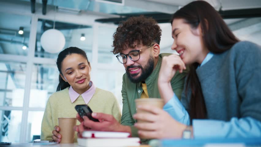 Female coworkers sitting with takeaway coffee cups. Group colleagues laughing during short pause. Women enjoying friendly conversation. Office tea m relaxing together in contemporary workspace.