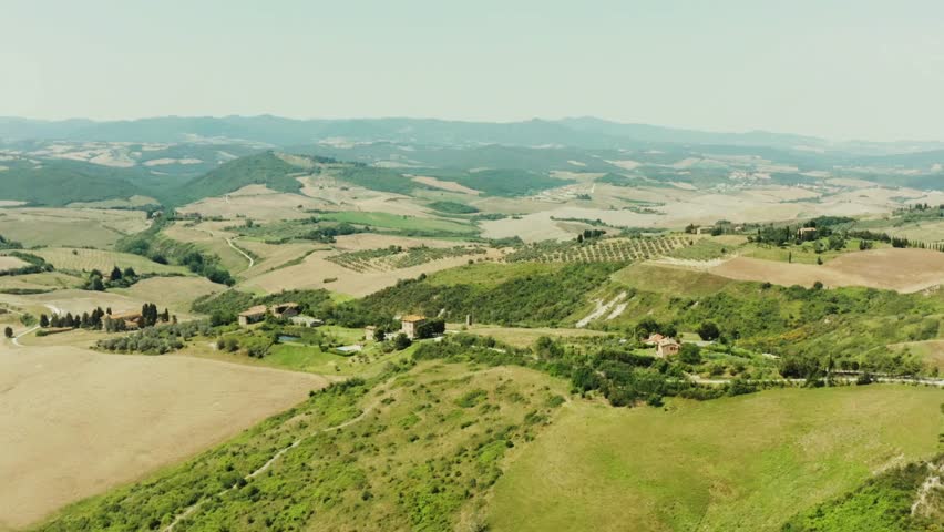 Panoramic aerial view of San Gimignano, Italy showcasing iconic historic town layout, terracotta rooftops, and scenic Tuscan countryside highlighting timeless European architecture captured in natural daylight.