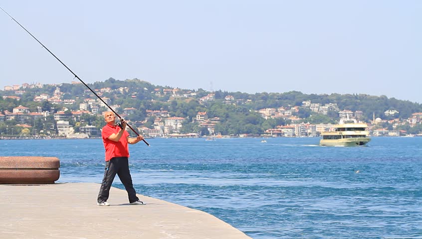 ISTANBUL - JUL 5: Fishermen pass the hours along the Bosporus on July 5, 2012 in