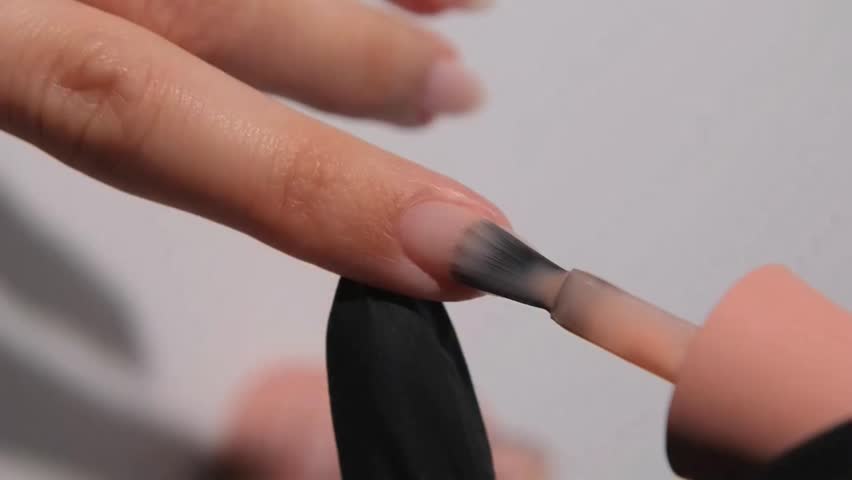 Close Up Video of Young Woman Applying Innovative Modern Professional Manicure in Nail Salon