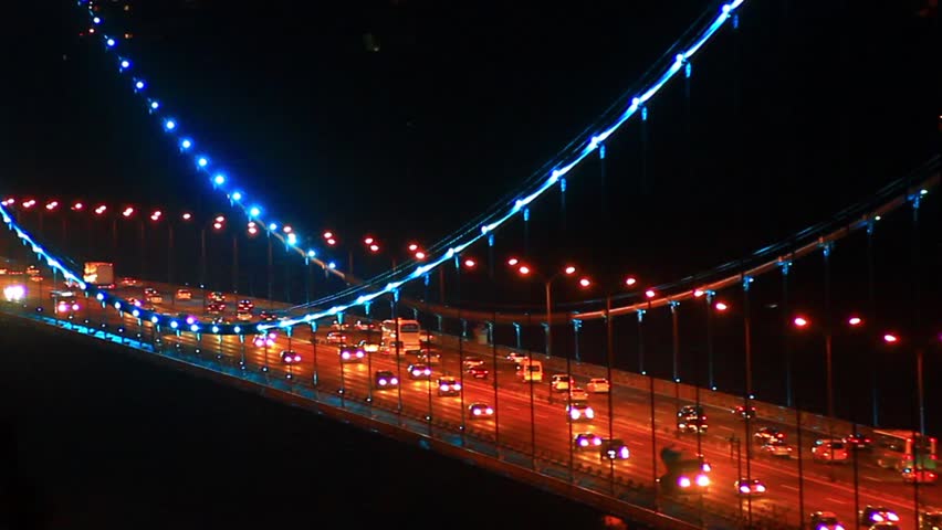 Night traffic on Trans European Motorway. Heavy traffic on suspended bridge
