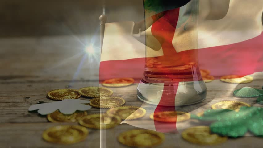 Lens flare appearing, flag billowing over tabletop with coins and clovers while hand adjusting rim. Banner, overlay, stilllife, closeup, warm, wooden, texture