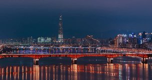 Timelapse unveils illuminated Seongsu Bridge in red lights with prominent Lotte World Tower piercing Seoul skyline amid Han River reflections and surrounding high-rise city glow - Powered by Shutterstock - Get 15% off with code: PIKWIZARD15