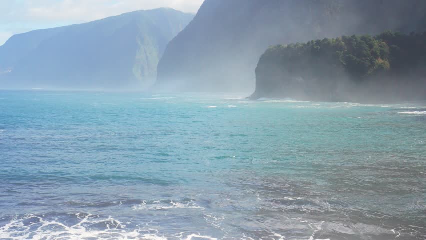 High steep cliffs over stormy ocean waves.