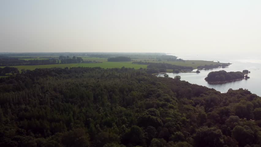 An aerial shot of the coastline of Lough Neagh during summer against bright summer sky.
