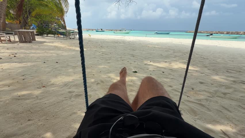 POV Swinging on Beach in Maldives with Turquoise Lagoon