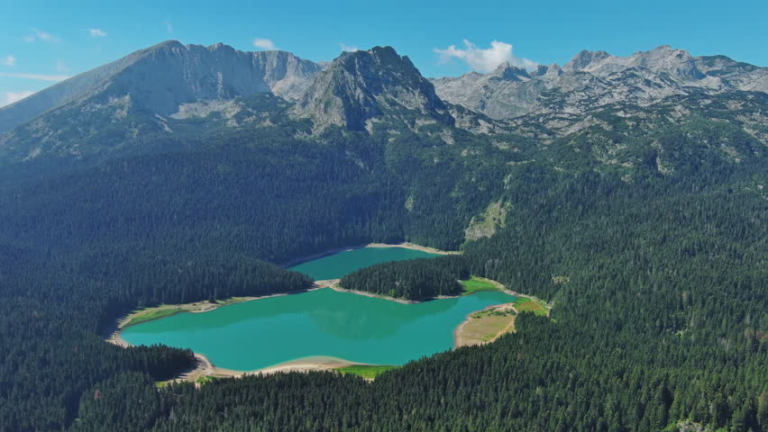 Aerial around view of Black Lake in mountain Durmitor park at summer, Montenegro, 4k