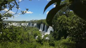Dolly in toward Alvar Nunez waterfalls across green rainforest gorge, Iguazu Falls Argentina. - Powered by Shutterstock - Get 15% off with code: PIKWIZARD15