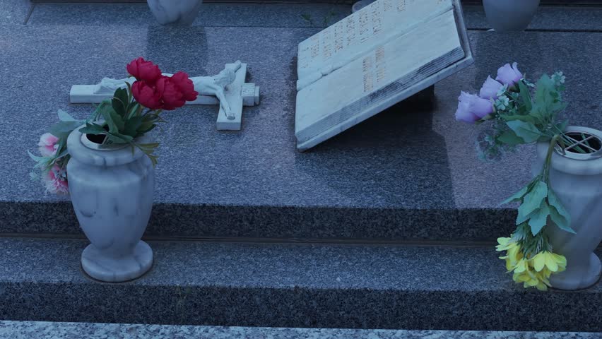 Capture the peaceful ambiance of a graveyard at sunset. Tombstones adorned with flowers and religious symbols create a solemn, atmospheric scene in Ferntree Gully, Melbourne.