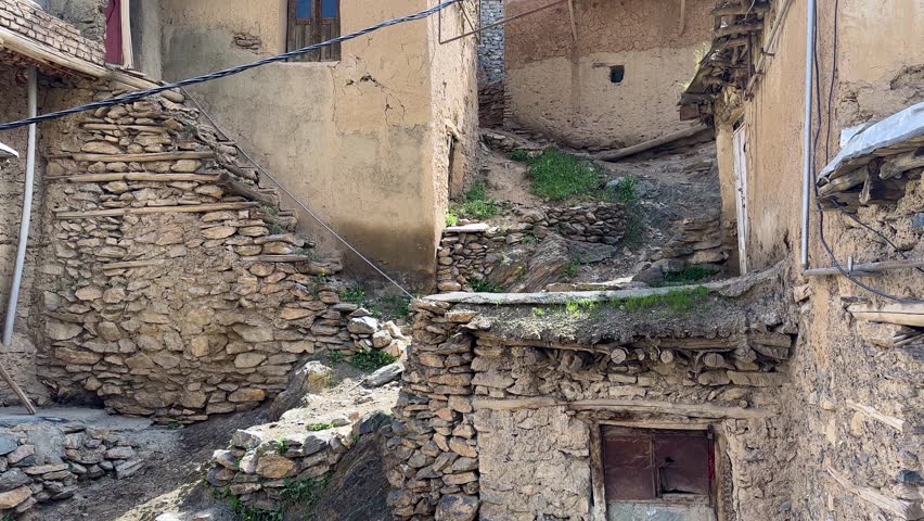 winding lane alleyway traditional stone terraced village cascade architecture in Iran scenic stepped brick Kurdistan rugged slope Zagros mountain local landscape earthen roof structure rustic timber