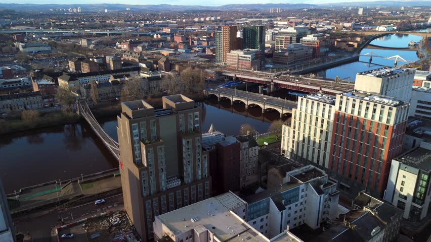 Glasgow Scotland: 13th Feb 2026: Glasgow Bridges over River Clyde, with buildings lining the waterfront. Drone view golden hour with city skyline