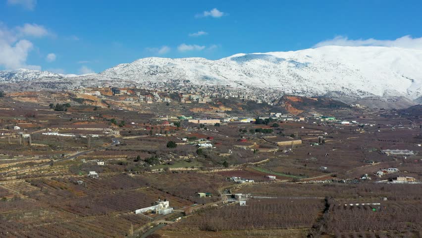 Aerial view of Majdal Shams village at the foot of snowy Mount Hermon, Golan Heights, Israel