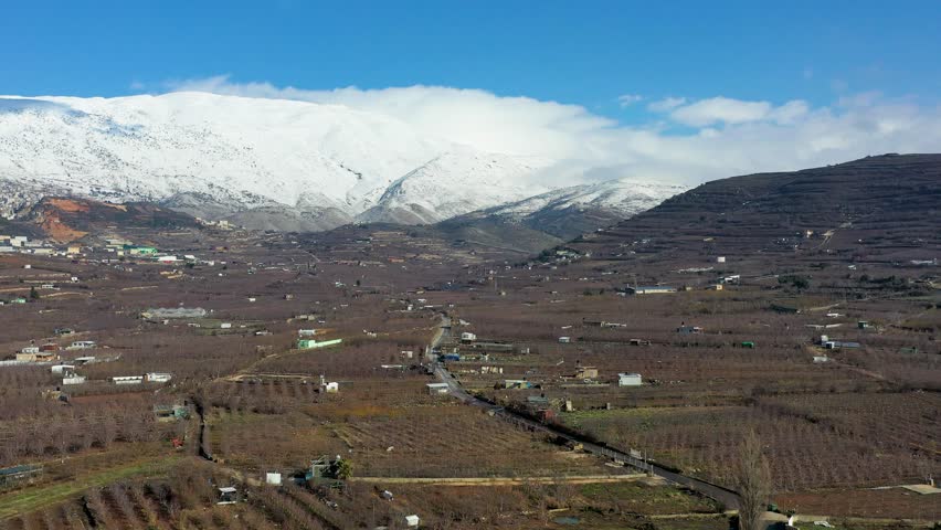 Aerial view of Majdal Shams village at the foot of snowy Mount Hermon, Golan Heights, Israel