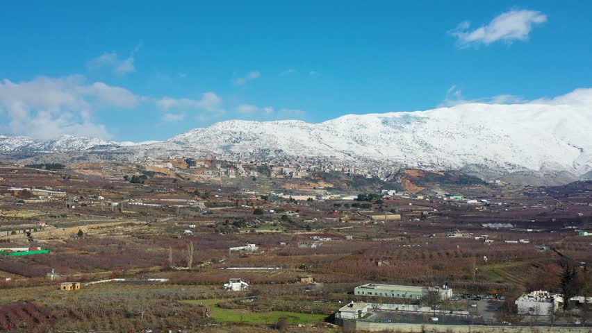 Aerial view of Majdal Shams village at the foot of snowy Mount Hermon, Golan Heights, Israel