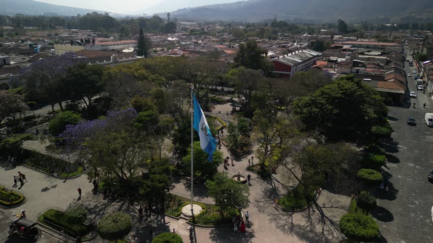 Aerial of Central Park in Antigua Guatemala reveal volcano of Volcan Agua
