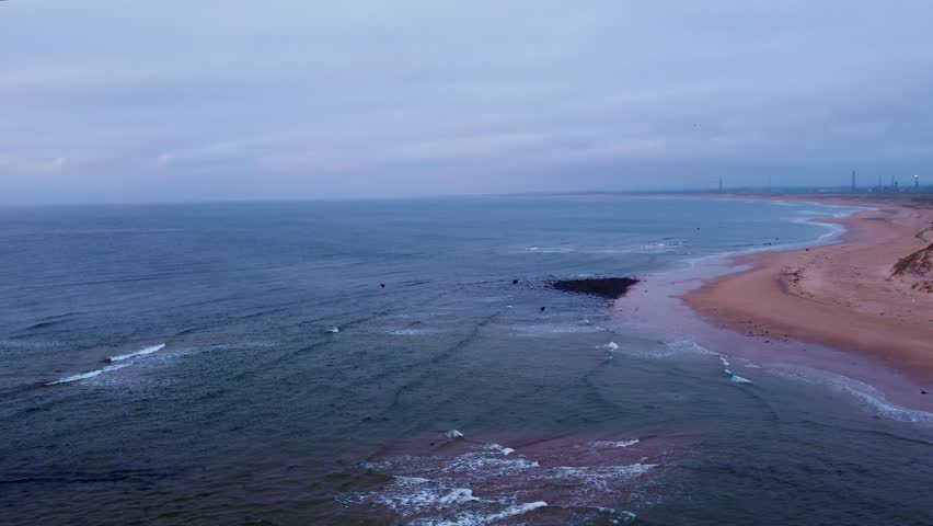 Tracking Drone Shot of Coast around Rattray Head in Scotland, early morning high tide.